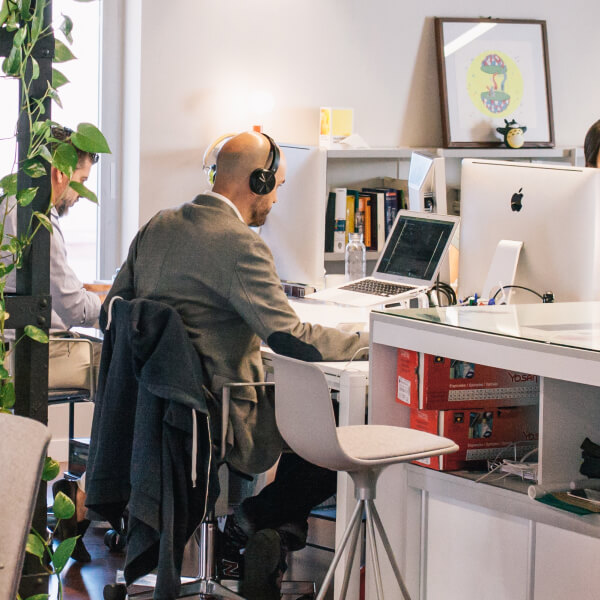 man working in office using ERP software in his laptop